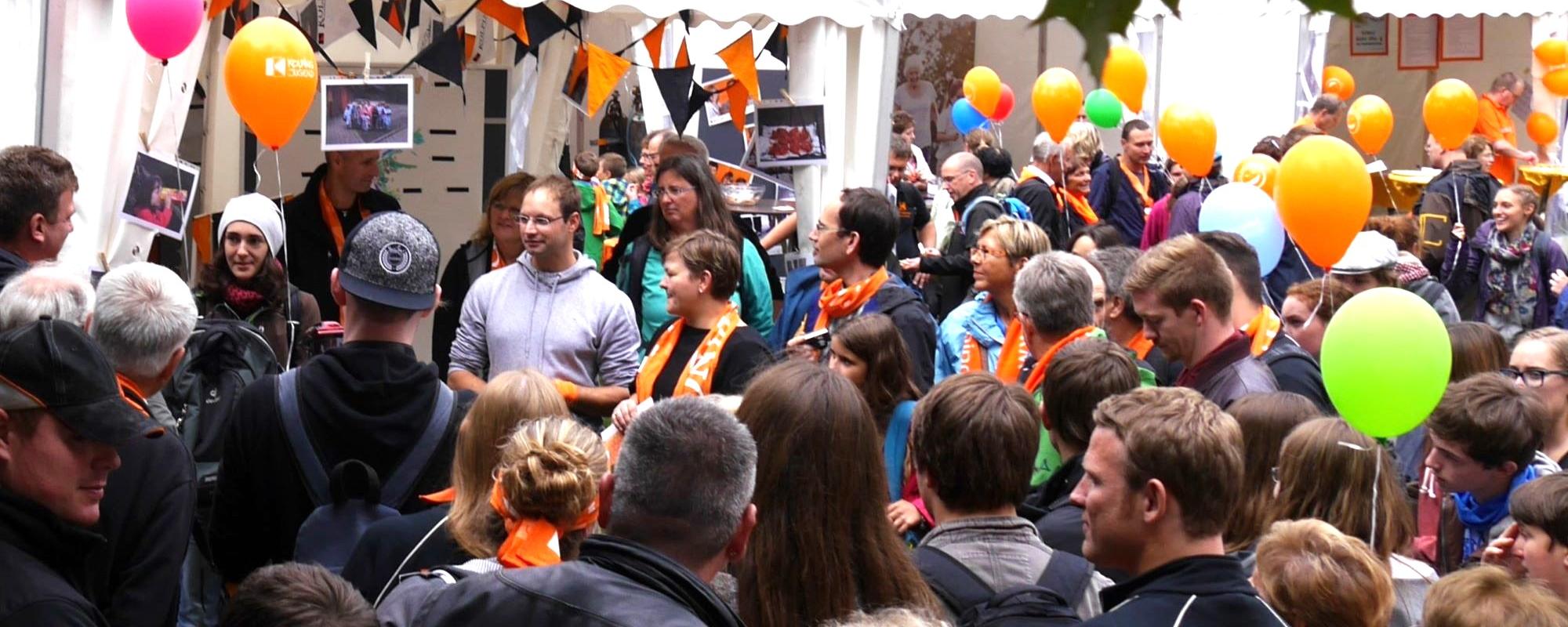 Man sieht eine Gruppe Menschen mit Kolpingschals und bunten Luftballons. (c) Martina Wagner Man sieht eine Gruppe Menschen mit Kolpingschals und bunten Luftballons.